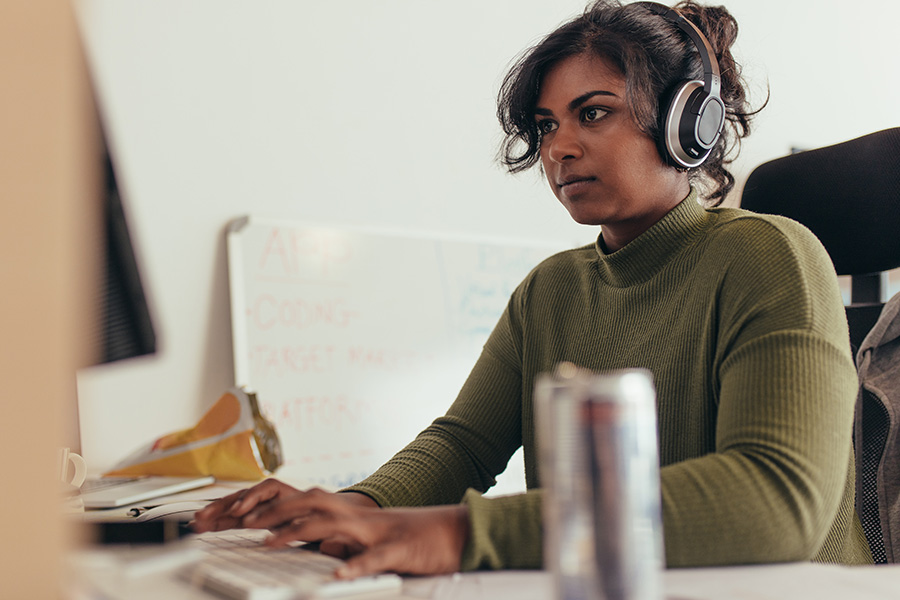 Woman wearing headphones working from home