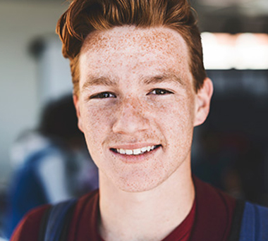 Smiling young man with freckles