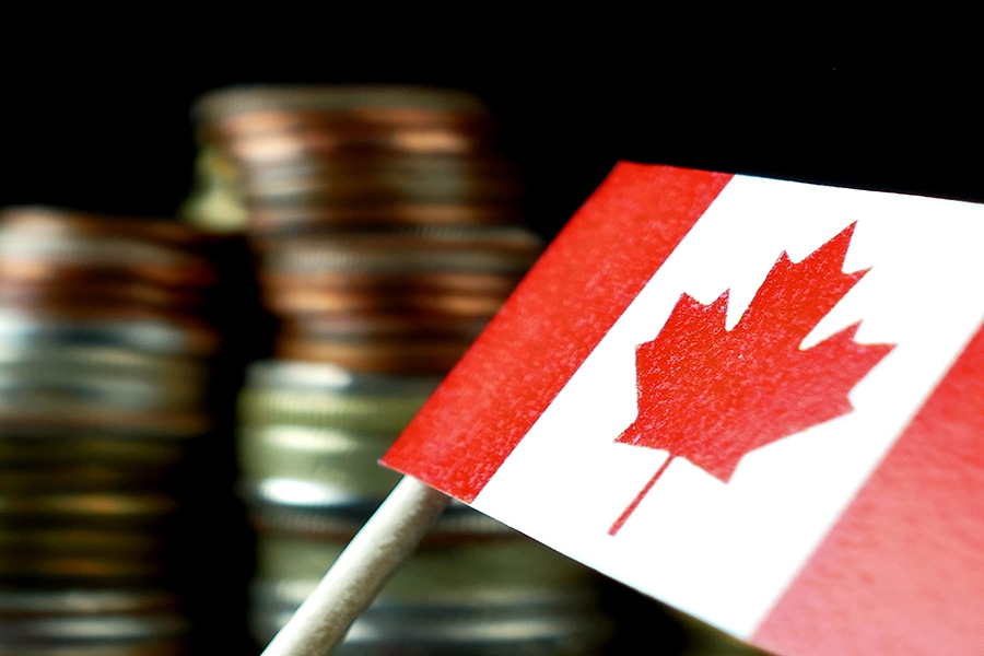 Canadian flag in front of stacks of coins