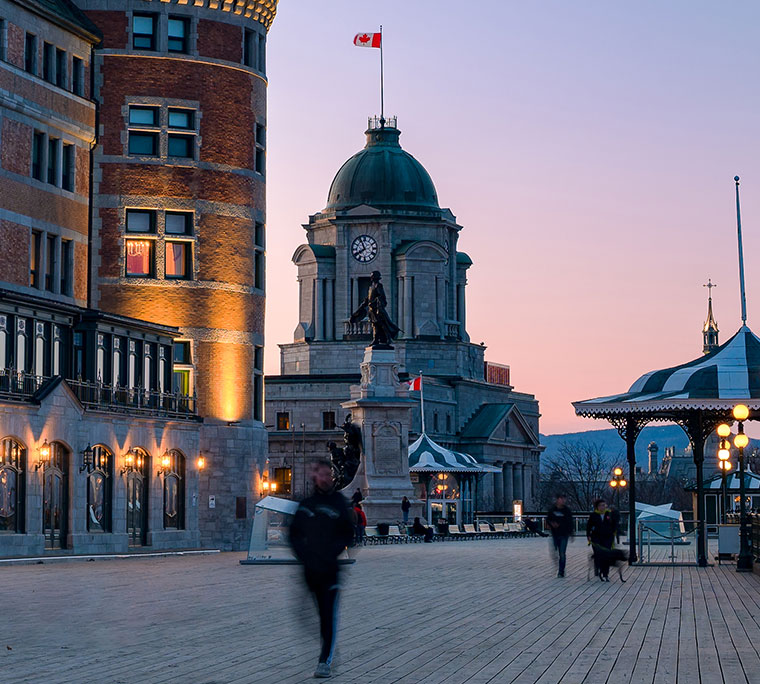 People walking on Dufferin terrace at dusk, close to Château Frontenac hotel, Quebec City, Quebec