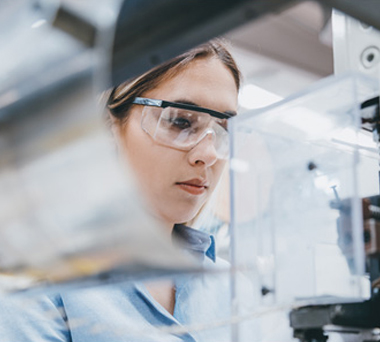 Woman wearing safety goggle working in a lab