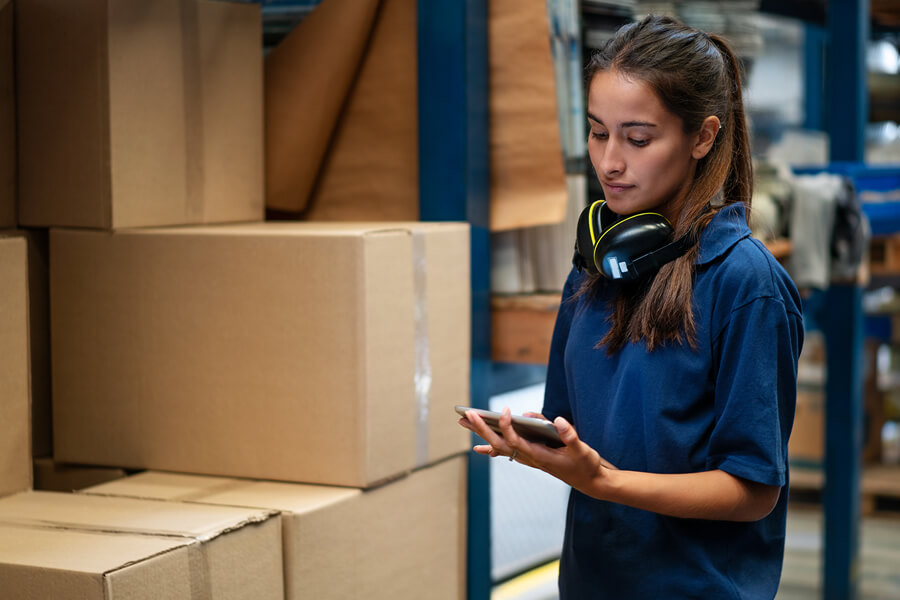 Woman tracking inventory in a warehouse