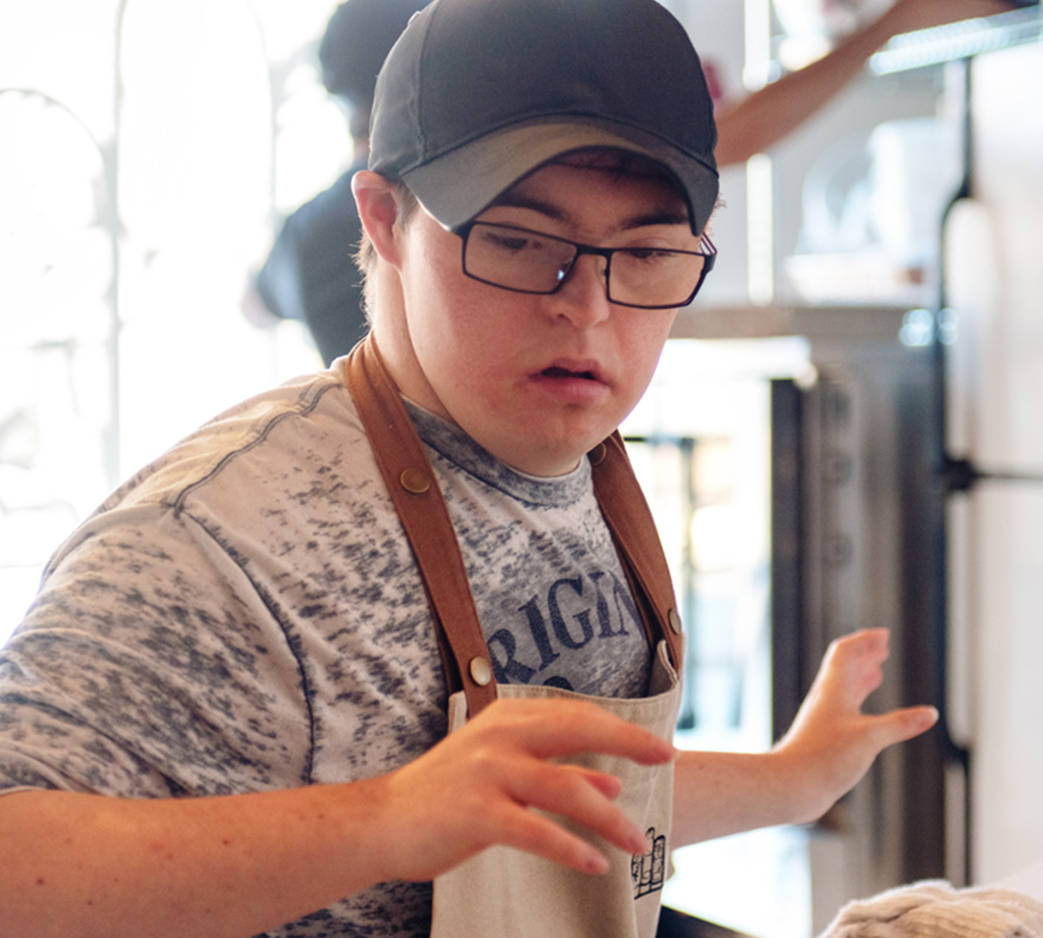 Person with disabilities working in restaurant kitchen.