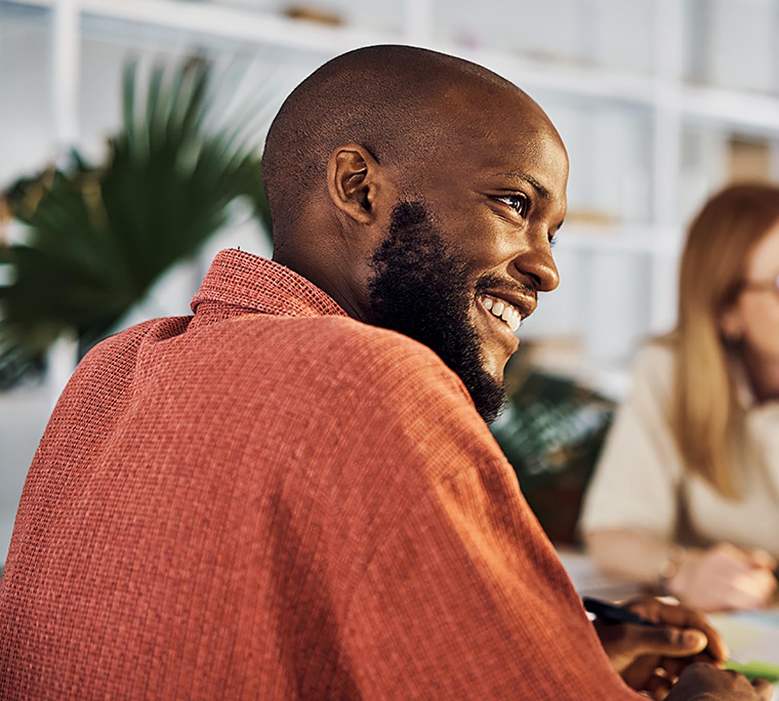African American man smiling in a meeting at work