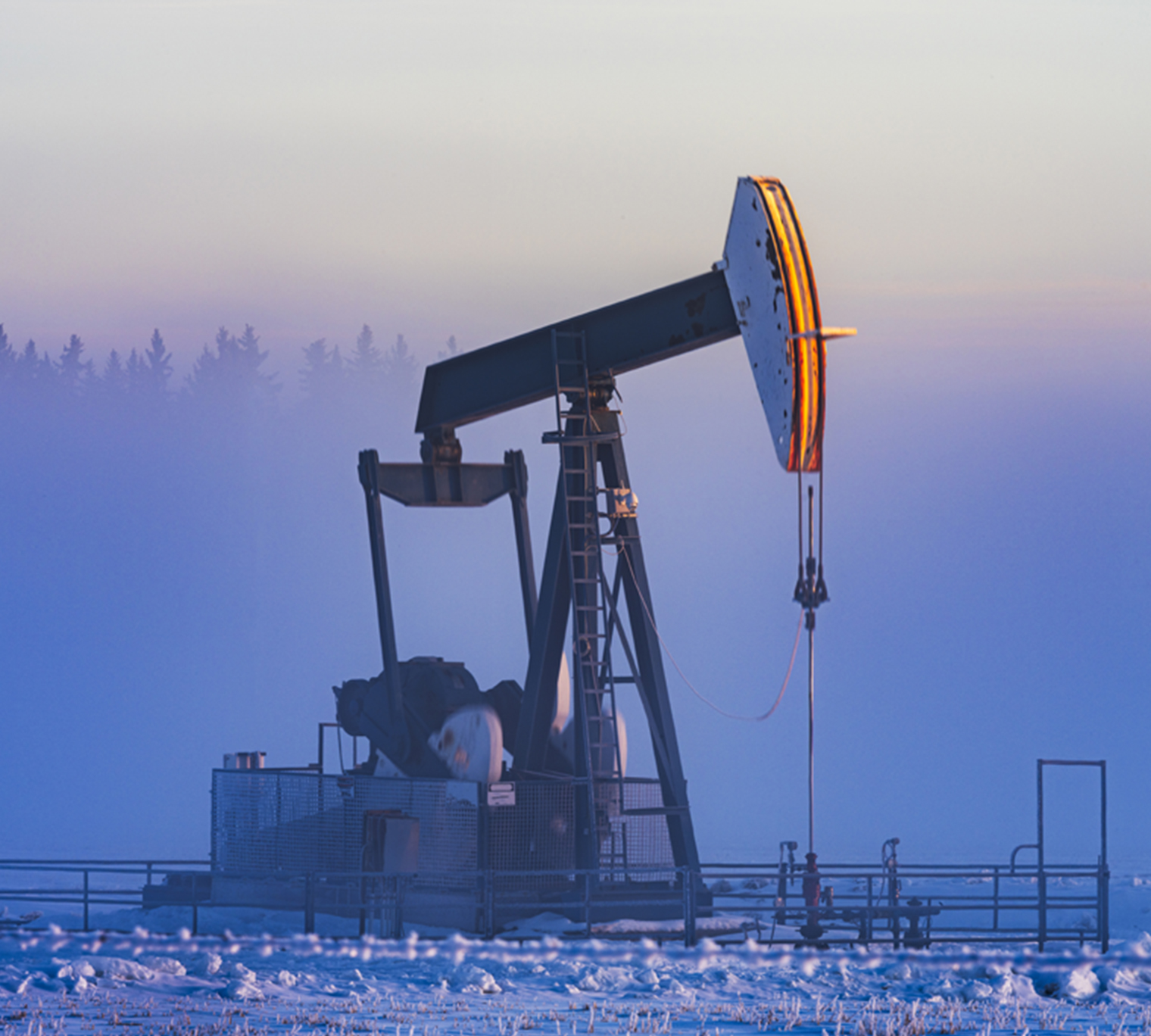 Oil pumping in winter morning, Alberta, Canada.
