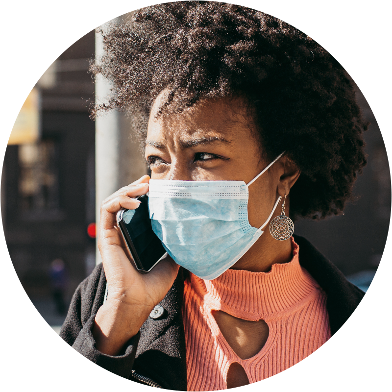 Person wearing mask for covid-19 protection while talking on a cell phone