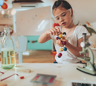 Child making molecule with toys