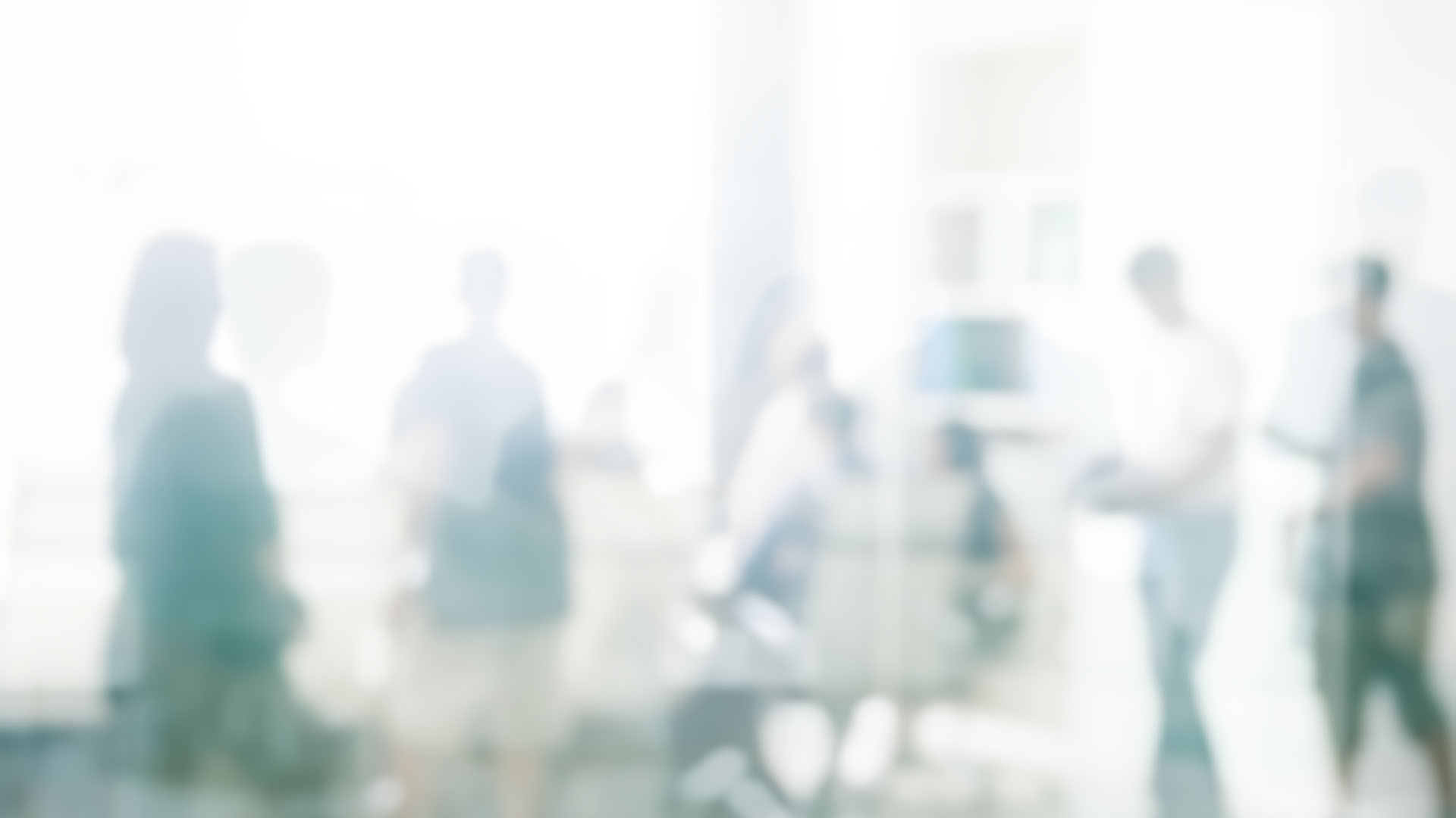 abstract blurry window of people coming together in an office meeting room