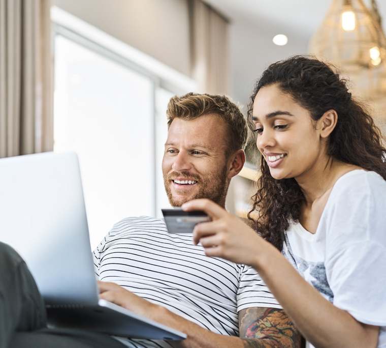 couple reviewing finances, couple on couch, couple paying bills