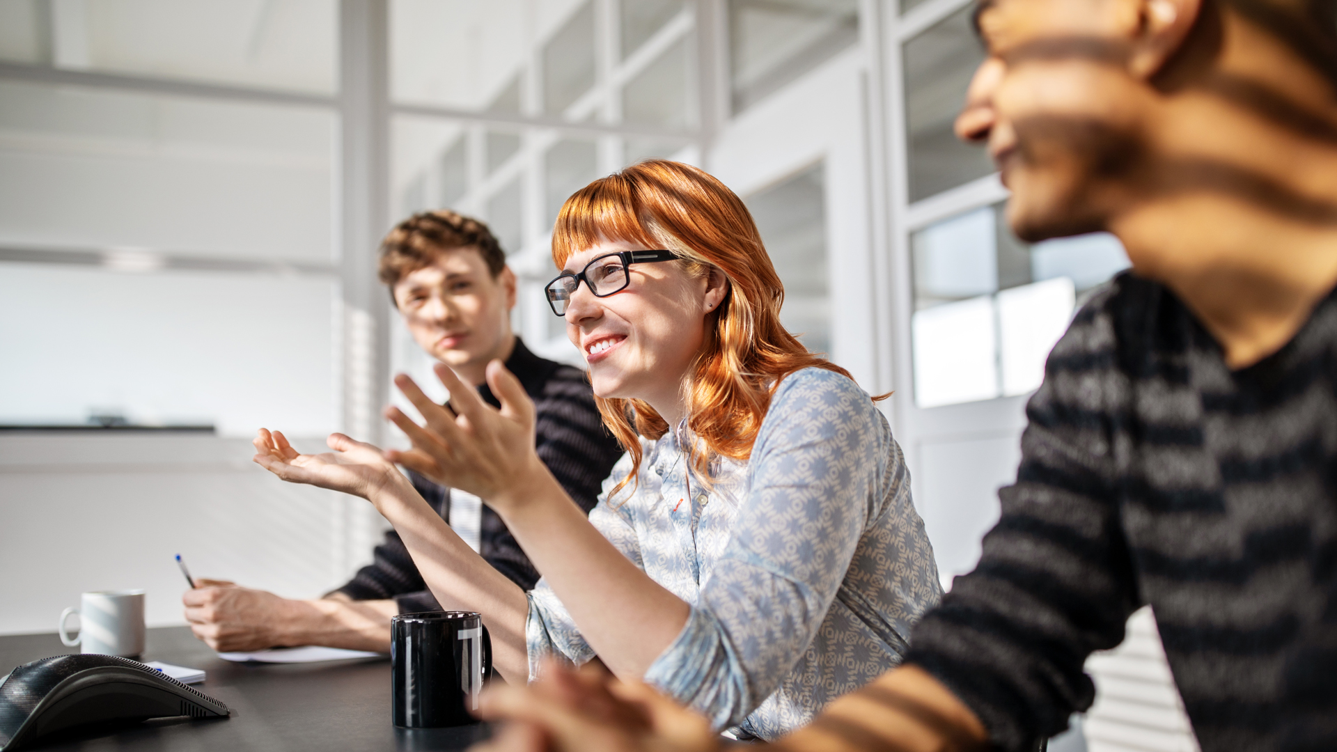 Woman speaking to group of colleagues