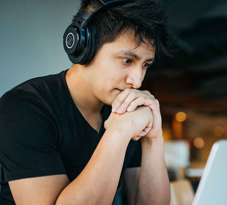 Man with headphones on computer