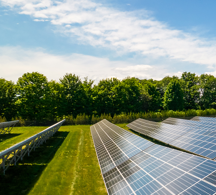 Rows of sustainable energy solar panels on farmland.
