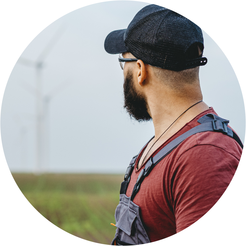 Person looking out over a wind turbine farm.