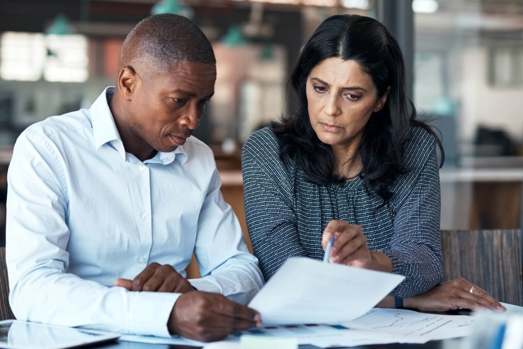 Two people going over paperwork in an office